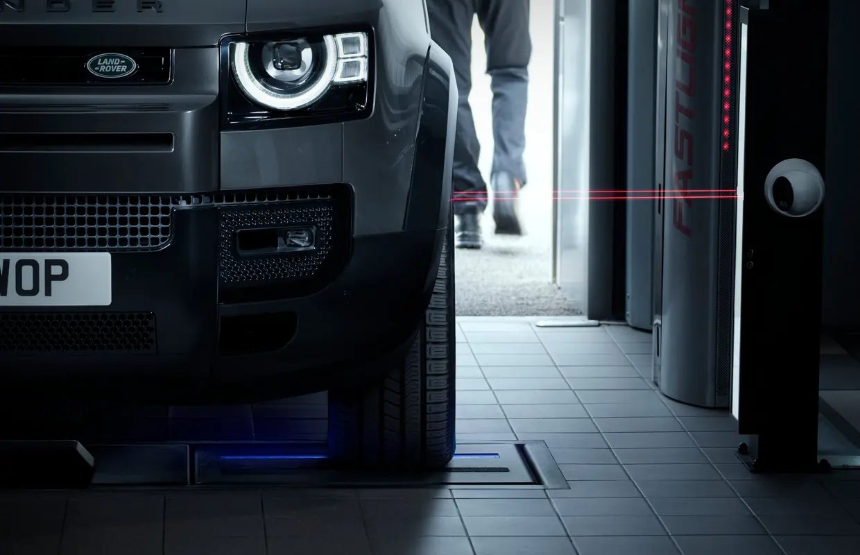 A Land Rover Defender on a laser tyre and alignment scanner in the workshop