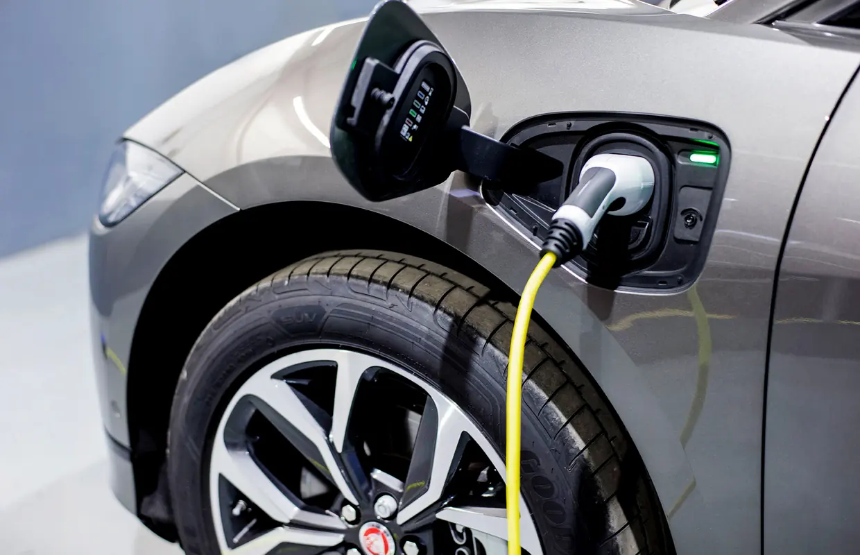 A charging cable plugged into the charge port of a Jaguar I-PACE