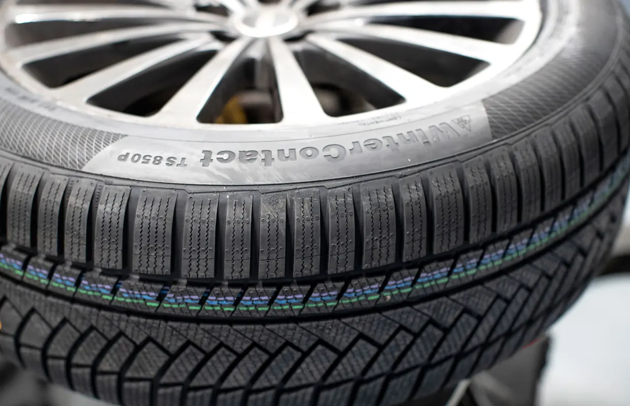 Close-up of a new Continental WinterContact tyre tread on an alloy wheel